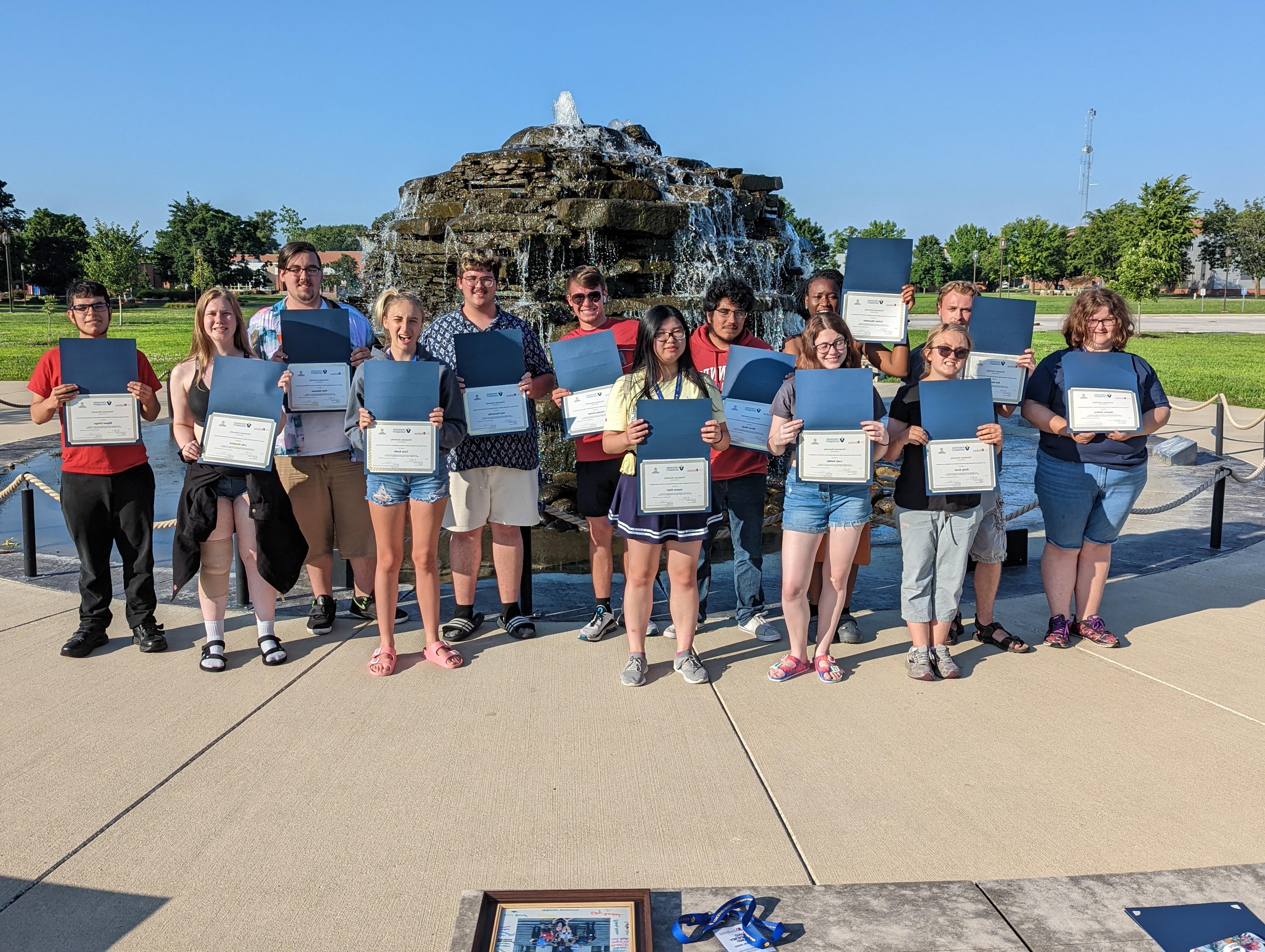 JAG Academy students posing for a photo in front of the Updike Fountain